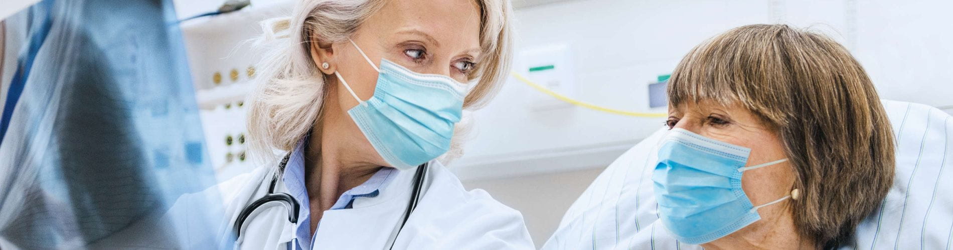 female doctor talking to older female patientabout xray